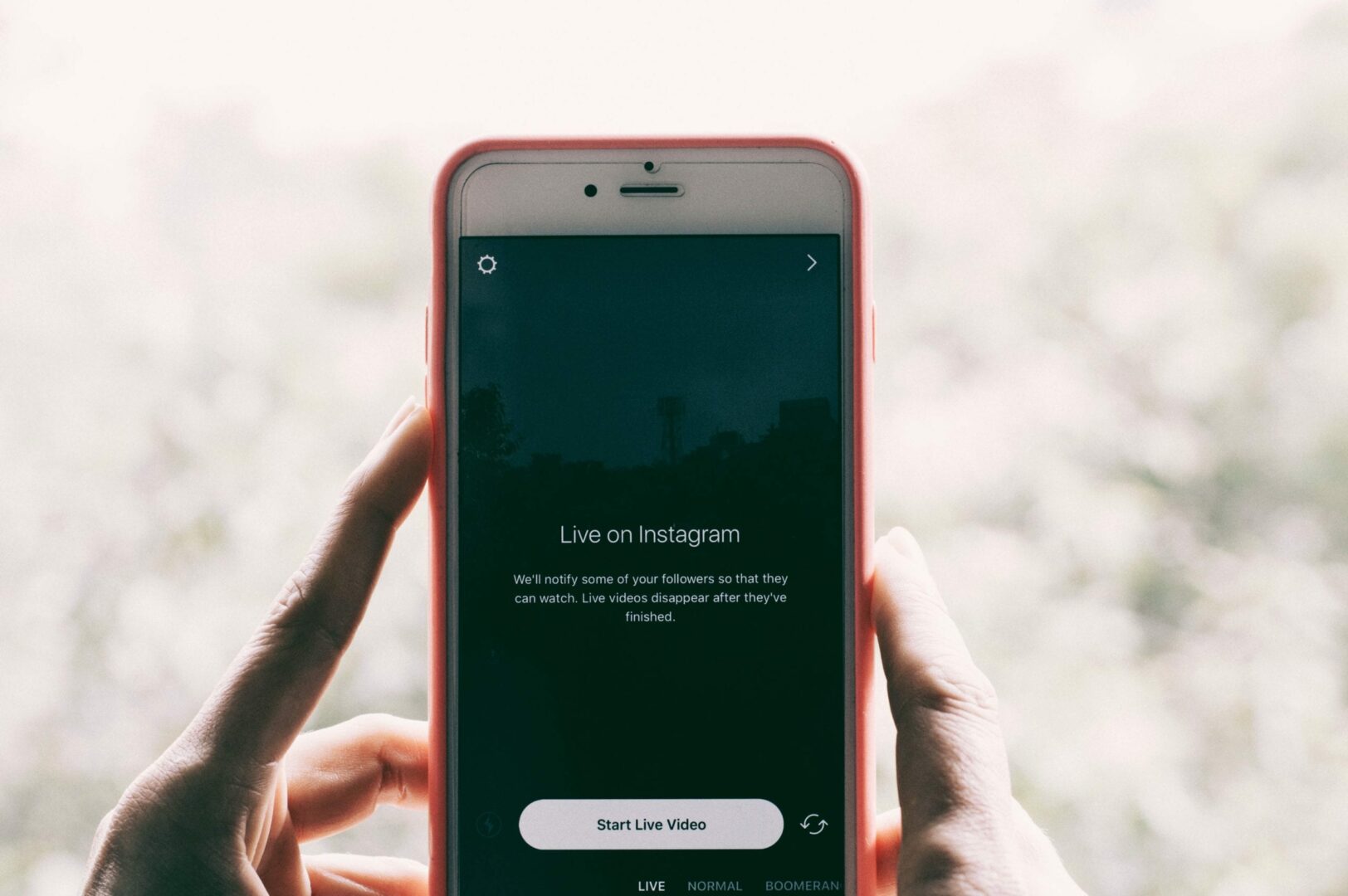 a shot of a phone showing the UI for Instagram Live on the screen