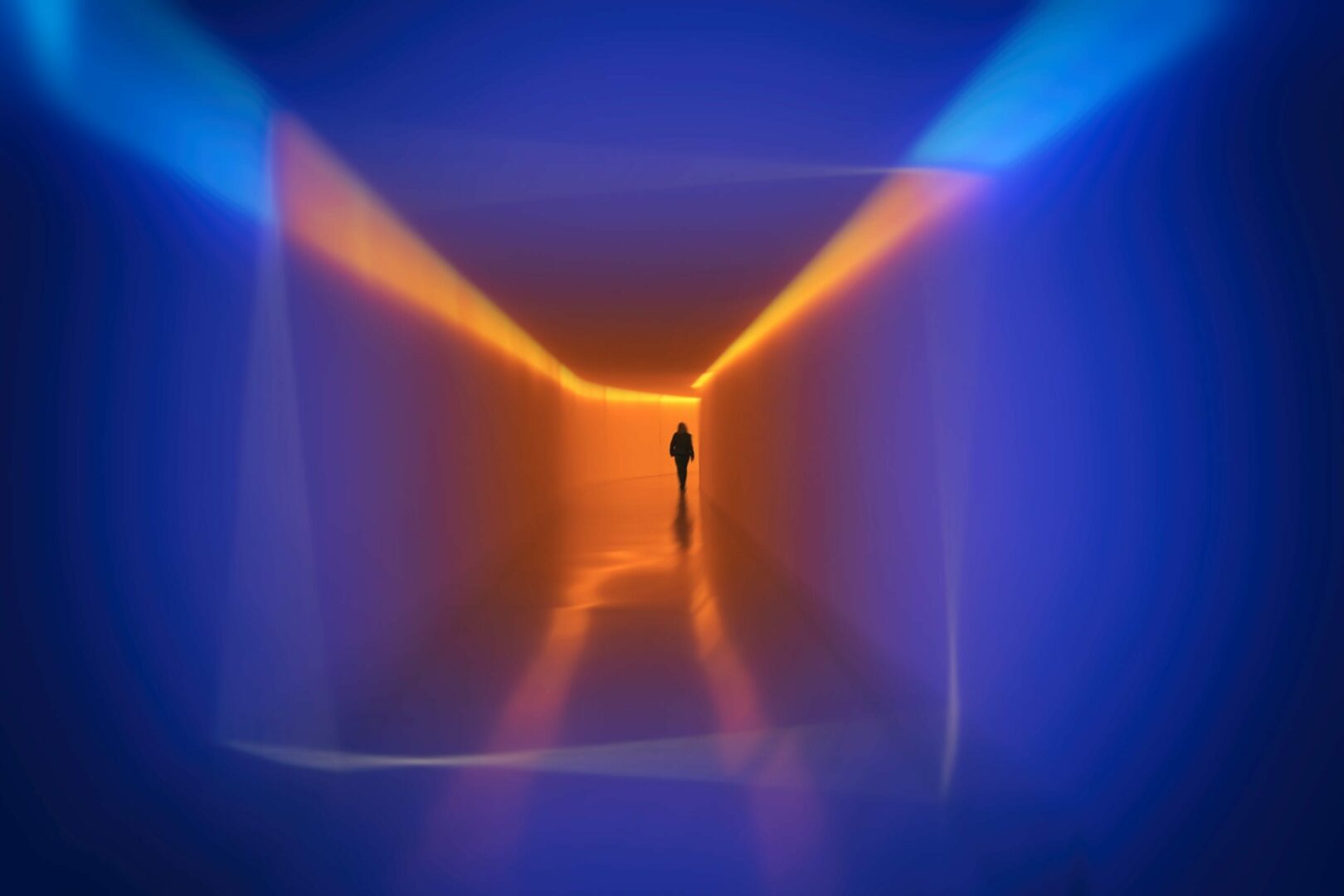 Man walking in blue and orange corridor