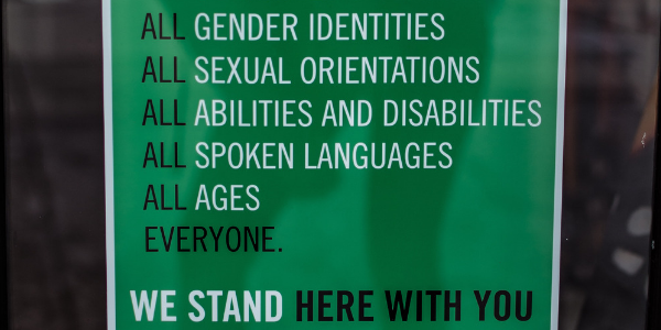 green sign that talks about inclusivity