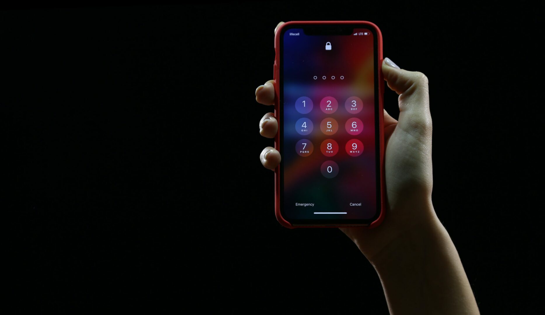 a shot of a hand holding a phone in the palm showing the lockscreen