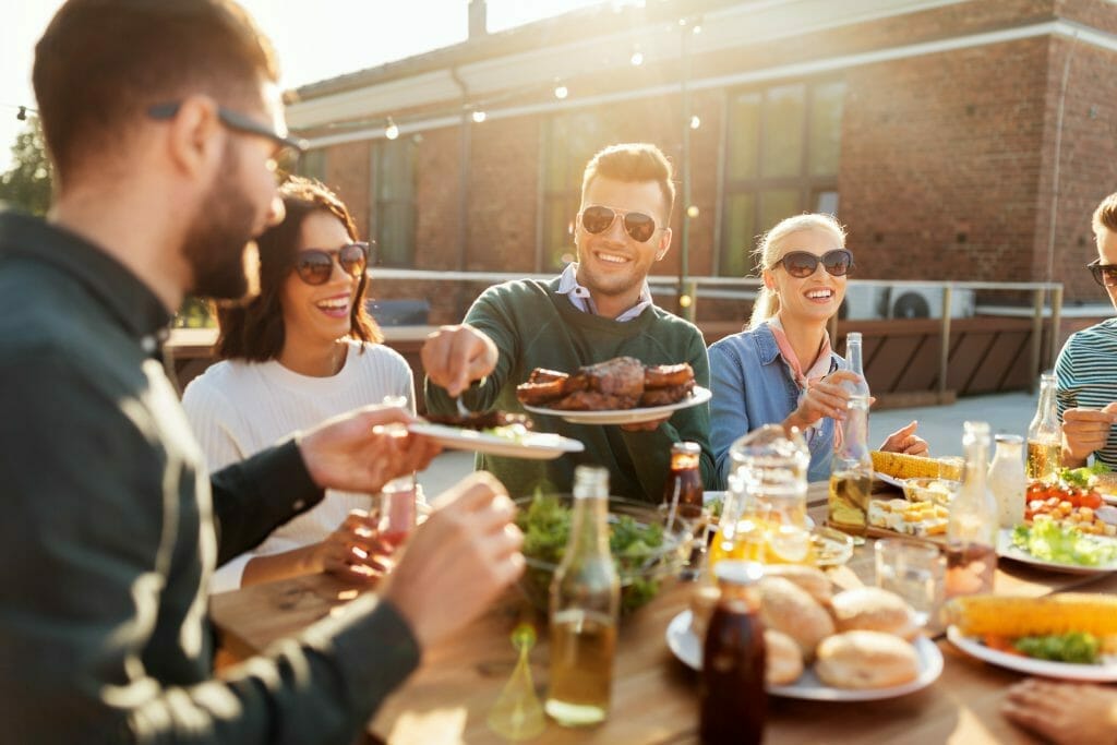 people eating and drinking outside together